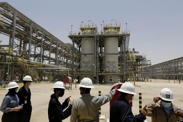 Saudi Aramco engineers and journalists look at the Hawiyah Natural Gas Liquids Recovery Plant in Hawiyah, in the Eastern Province of Saudi Arabia in 2021.