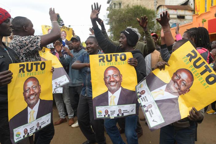 Supporters of Kenya's president-elect William Ruto hold posters of him as they gather while waiting for results of Kenya's general election in Eldoret, Kenya, on Monday.