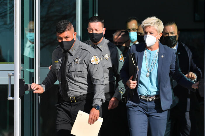 County and state officials exit the Santa Fe County Public Safety Building in New Mexico ahead of a news conference to update members of the media on the shooting accident on the set of the movie <em>Rust</em>.