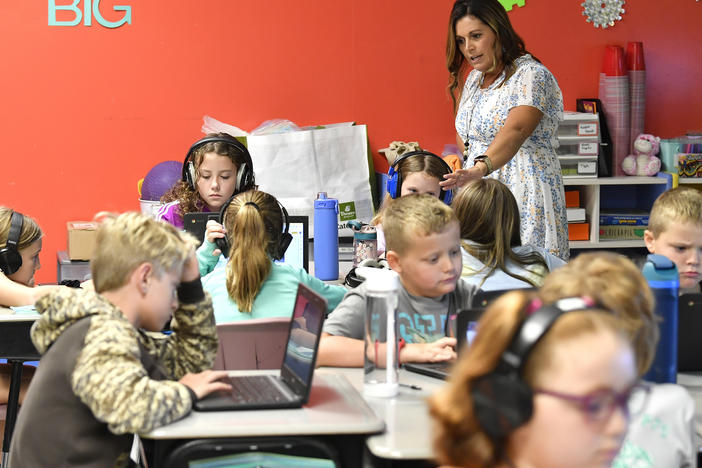 Angela Pike watches her fourth grade students at Lakewood Elementary School in Cecilia, Ky., as they use their laptops to participate in an emotional check-in at the start of the school day, Thursday, Aug. 11, 2022.