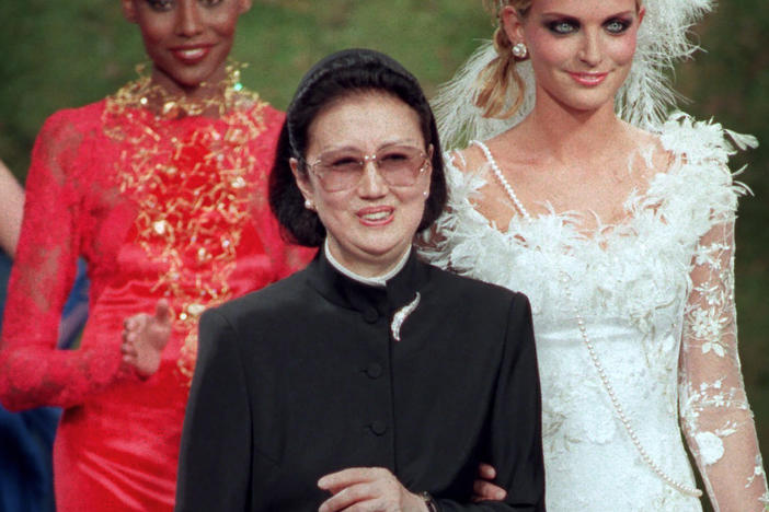 Japanese fashion designer Hanae Mori, center, is applauded by models after the presentation of her 1997-98 fall-winter haute couture collection presented in Paris, July 9, 1997.