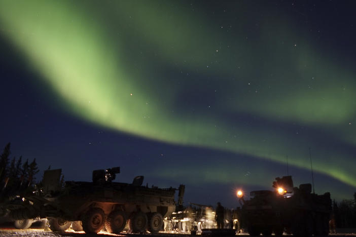 In this Sept. 15, 2017, photo provided by the U.S. Army Alaska, soldiers from Alpha Company, 70th Brigade Engineer Battalion, 1st Stryker Brigade Combat Team, 25th Infantry Division, based at Fort Wainwright, Alaska, conduct unscheduled field maintenance under the Northern Lights on a squad vehicle in preparation for platoon external evaluations at Donnelly Training Area, near Fort Greely.