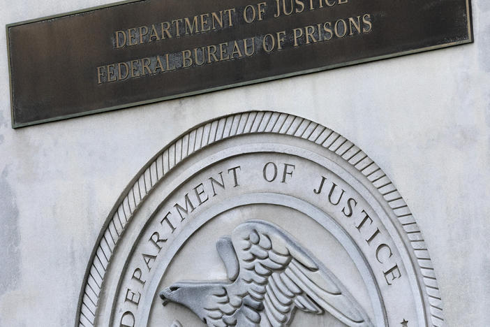 In this 2020 photo, a sign for the Department of Justice Federal Bureau of Prisons is displayed at the Metropolitan Detention Center in the Brooklyn borough of New York.