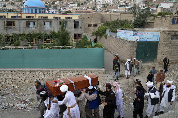 Mourners carry the body of a victim of a mosque bombing in Kabul, Afghanistan, Thursday, Aug. 18. 2022.