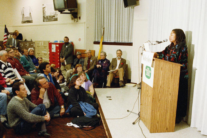 In 1989, after Iran's religious leader, Ayatollah Ruhollah Khomeini, issued a fatwa calling for the death of author Salman Rushdie, readings of his works were organized around the United States. At this one in San Francisco, novelist Alice Walker reads aloud from Rushdie's <em>The Satanic Verses</em>.