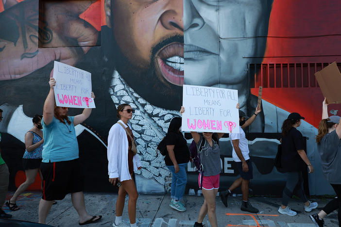 People march to protest the Supreme Court's decision in the <em>Dobbs v Jackson Women's Health</em> case on June 24 in Miami.