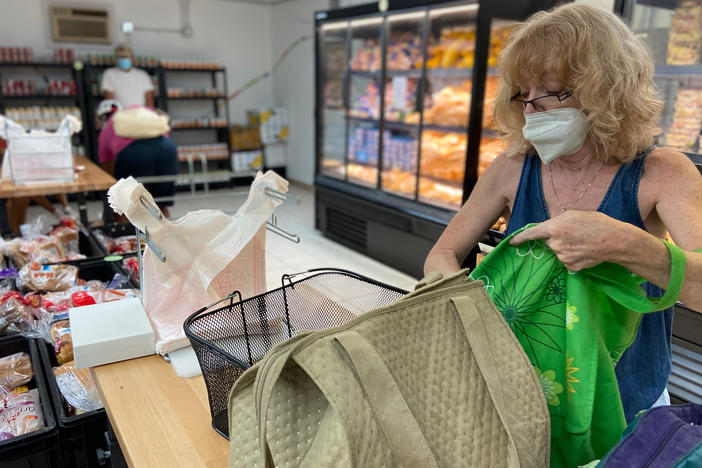 Jill Mallen gets her groceries at a food pantry because of soaring inflation. She says she's a "confused" voter — a registered Democrat who feels Republicans did a better job of managing the economy.