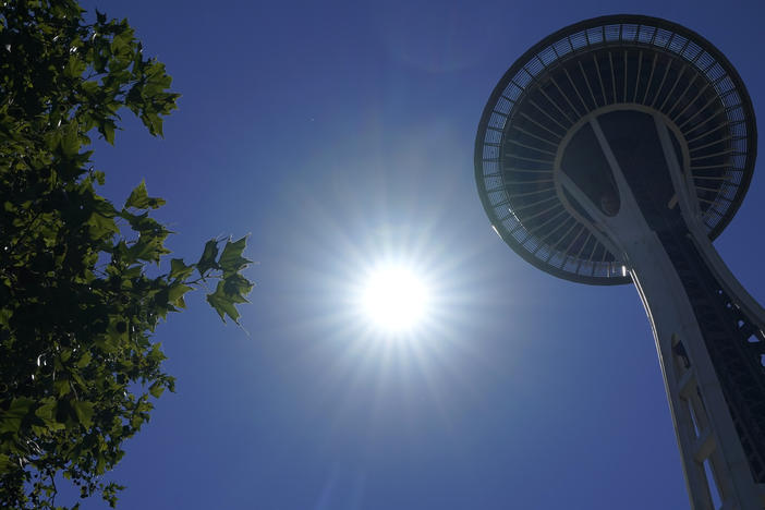 The sun shines near the Space Needle, Monday, June 28, 2021, in Seattle.