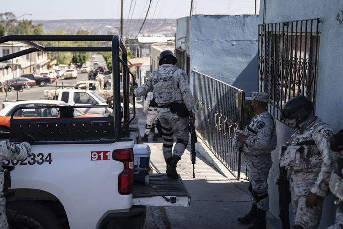 Members of the National Guard stand guard outside a military base in Tijuana.