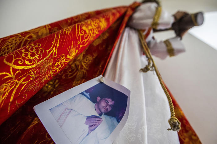 An image of Bishop Rolando Álvarez is pinned to a robe on a statue of Jesus Christ at the Cathedral in Matagalpa, Nicaragua, on Friday. Nicaraguan police on Friday raided Alvarez's residence, detaining him and several other priests in an escalation of tensions between the Catholic Church and the government of Daniel Oretga.