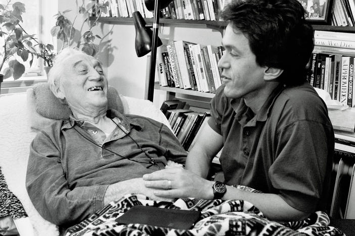 Mitch Albom and Morrie Schwartz hold hands on Oct. 3, 1995.