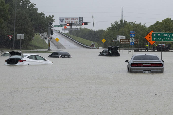 Stalled cars sit abandoned on the flooded Interstate 635 Service Road on Monday in Mesquite, Texas.
