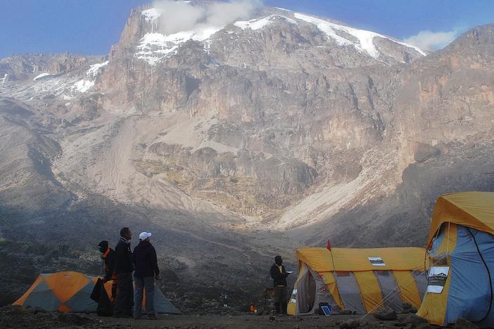 Hikers stand by tents along a trekking route on Mount Kilimanjaro in 2014. The Tanzanian government has installed high-speed internet service on the slopes of the mountain.