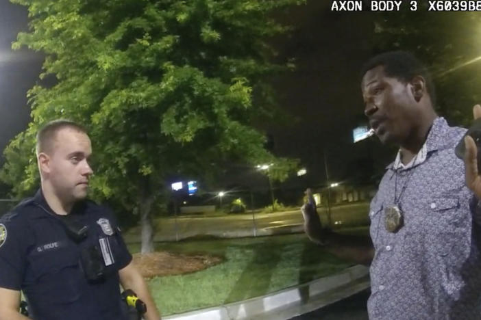 This screen grab taken from body camera video provided by the Atlanta Police Department shows Rayshard Brooks, right, as he speaks with Officer Garrett Rolfe, left, in the parking lot of a Wendy's restaurant in Atlanta on June 12, 2020.