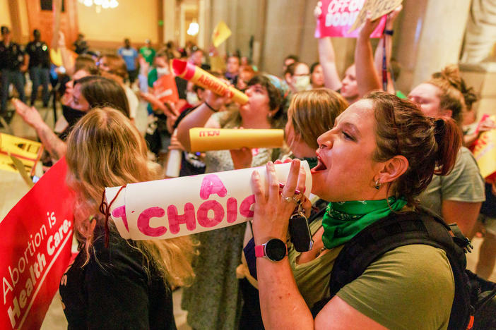 Abortion rights activists chant slogans as the Indiana Senate debates during a special session in Indianapolis before voting to ban abortions.