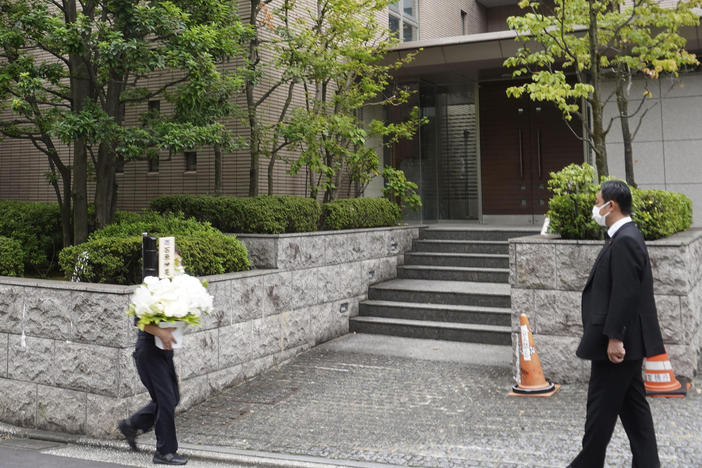 Flowers arrive at the residence of former Prime Minister Shinzo Abe in Tokyo Thursday, Aug. 25, 2022. Abe's family paid tribute to him in a private ritual Buddhist ritual Thursday marking the 49th day of his assassination.