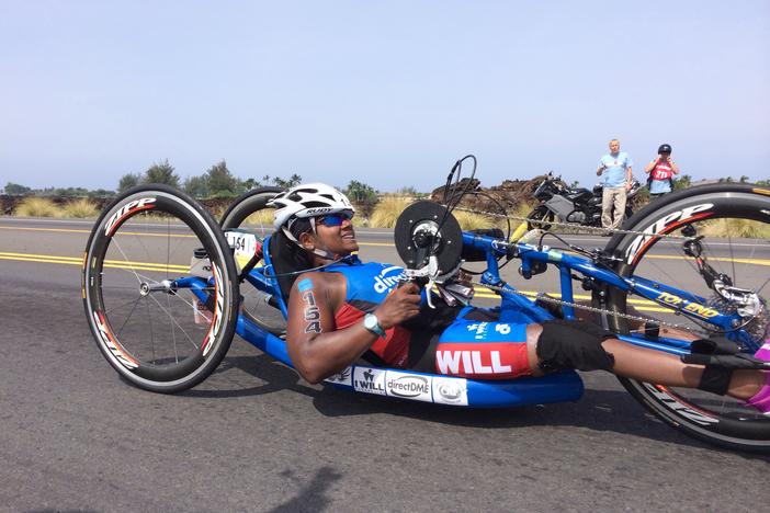 Minda Dentler handcycling at mile 32 of The Kona Ironman in Hawaii, 2013. She's the first female wheelchair athlete to complete the Ironman World Championship. When she was an infant, her legs were paralyzed by polio. "I wish all people who may be on the fence about vaccination could really meet me," she says. "I'm a reminder to families that they should vaccinate their children."