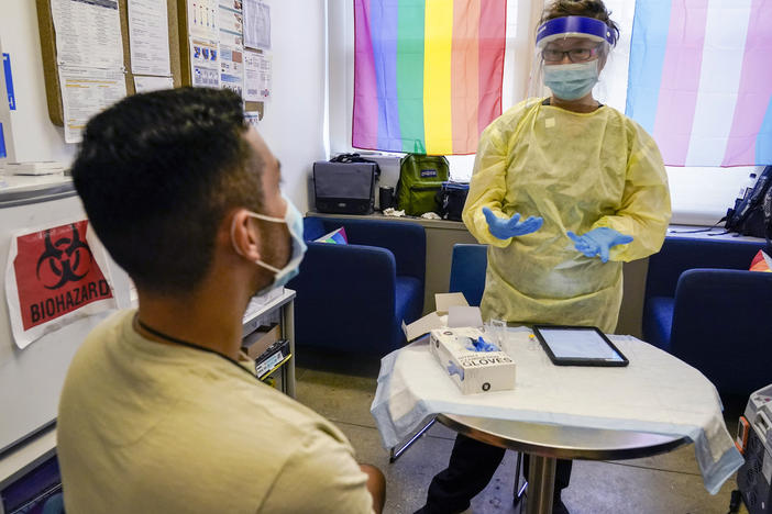 Physician Assistant Susan Eng-Na, right, administers a monkeypox vaccine during a vaccination clinic in New York. New cases are starting to decline in New York and some other U.S. cities.