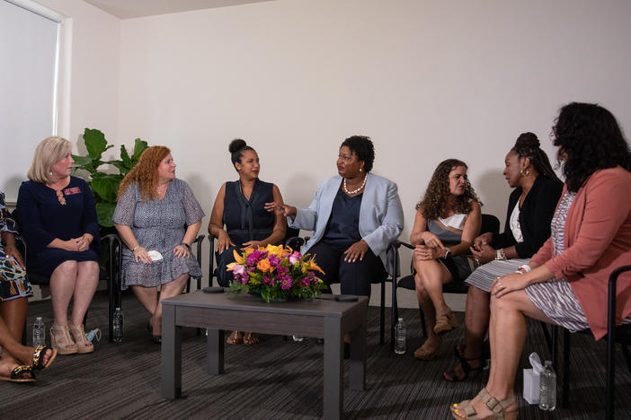 Georgia Democratic gubernatorial candidate Stacey Abrams joins a group of women as they discuss their personal stories of miscarraige at her campaign headquarters in Decatur, Ga. on Aug. 3.