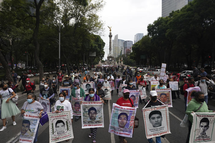 Family members and friends march seeking justice for the missing 43 Ayotzinapa students in Mexico City on Friday.