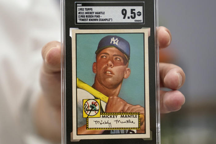 A Mickey Mantle baseball card is displayed at Heritage Auctions in Dallas, earlier this summer. A mint condition Mantle card has sold for $12.6 million, blasting into the record books.