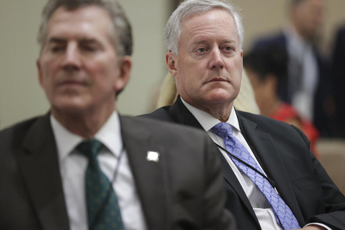 Former White House chief of staff Mark Meadows, right, and former Republican Sen. Jim DeMint, left, attend a summit organized by the America First Policy Institute on July 25. Meadows and DeMint have both been involved with the Conservative Partnership Institute, a nonprofit raising concerns among tax experts.