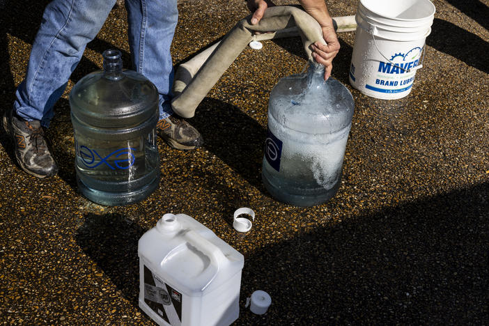 Ty Carter fills containers with nonpotable water on Aug. 31 in Jackson, Mississippi. The state's capital is struggling with access to safe drinking water after historic rain and flooding led to a drop in pressure at Jackson's main water-treatment plant on Aug. 29.