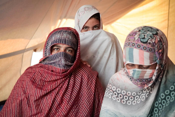 Left to right: Nazia, Mubina and Leila saw their homes washed away in the flooding. They now share a tent at a technical college that has been converted into a camp for displaced people.