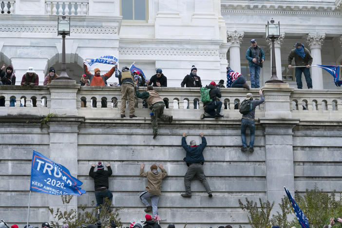 Insurrectionists loyal to President Donald Trump scale the west wall of the the U.S. Capitol on Jan. 6, 2021.