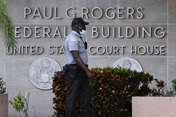 A security officer guards the entrance to the Paul G. Rogers Federal Building and Courthouse in West Palm Beach, Fla., on Thursday, where a federal judge presided over arguments at a hearing on former President Donald Trump's request for a special master to review classified documents the FBI seized from his home last month.