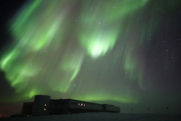 The aurora australis over Amundsen-Scott South Pole Station in 2009. A new report from the National Science Foundation finds sexual harassment and assault are a major problem at remote facilities.