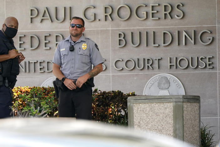 Law enforcement officers stand outside of the federal courthouse in West Palm Beach, Fla., on Aug. 18.