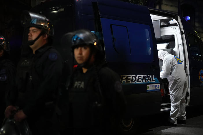 A police investigator works in his van at the scene where a man pointed a gun at Argentina's Vice President Cristina Fernandez during an event in front of her home in Buenos Aires, Argentina, Sept. 1, 2022.