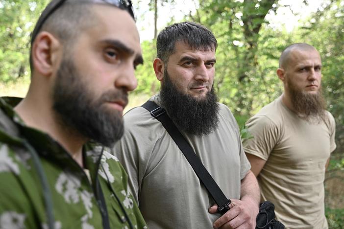 Members of the volunteer Sheikh Mansur Battalion (from left) Islam, Mansur and Asadulla speak to an AFP journalist during an interview in Zaporizhzhia on June 9. The Sheikh Mansur Battalion was founded in 2014 after the annexation of Crimea and composed mainly of Chechen veterans. The group was named after a Chechen military commander against Russian expansion in the Caucasus in the 18th century.