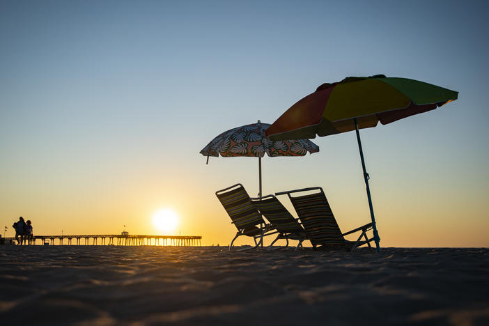 Beach chairs are seen as the sun rises in Ocean City, N.J., on Aug. 18. This is not the above-average hurricane season experts predicted — at least, not yet.