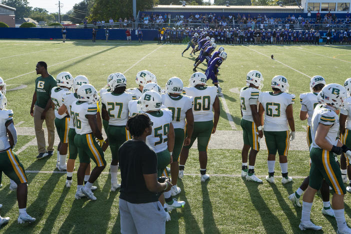 The Belhaven University football team stands on the sidelines as their game against Millsaps College begins on Thursday.