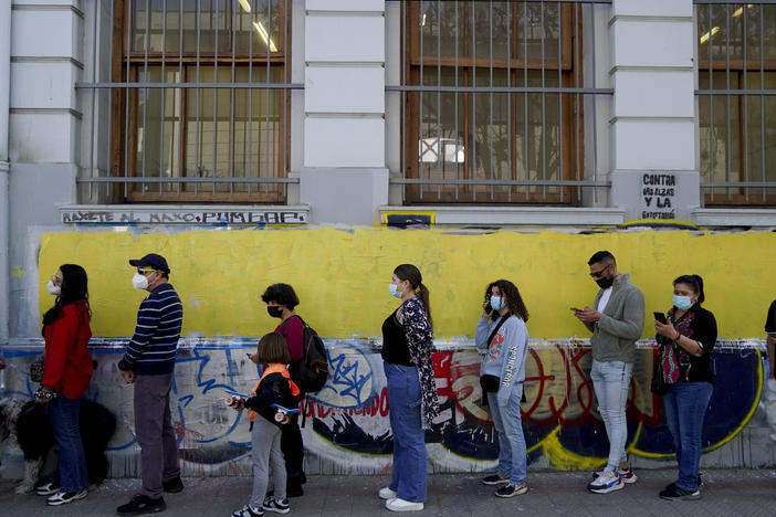 People line up to vote in a plebiscite on a new draft of the Constitution in Santiago, Chile, Sunday.