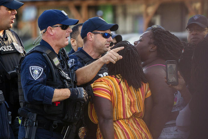 Brittany Martin, center,  confronts police as demonstrators march in protest of George Floyd's death May 2020 in downtown Sumter, S.C. Martin, a pregnant Black activist serving four years in prison for her behavior at racial justice protests, is scheduled to have her sentence reconsidered as she struggles to reach her due date behind bars.