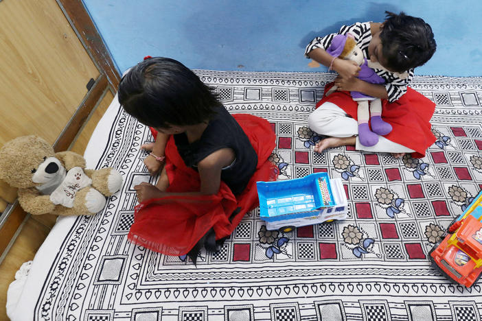 Twin sisters Tripti and Pari, who lost both their parents to COVID-19, play at a relative's home in Bhopal, India on May 11, 2021. A new study estimates that 8 million kids lost a parent or primary caregiver to a pandemic-related cause.