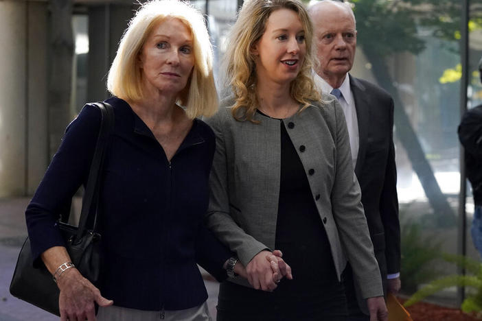 Former Theranos CEO Elizabeth Holmes, center, her mother, Noel Holmes, left, and father, Christian Holmes IV, arrive Sept. 1 at federal court in San Jose, Calif.
