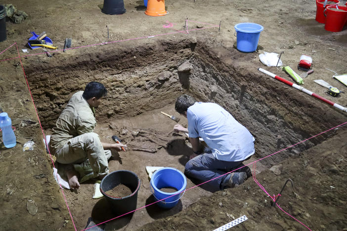 Dr. Tim Maloney and Andika Priyatno work at the site in a cave in East Kalimantan, Borneo, Indonesia, on March 2, 2020. The remains, which have been dated to 31,000 years old, mark the oldest evidence for amputation yet discovered.