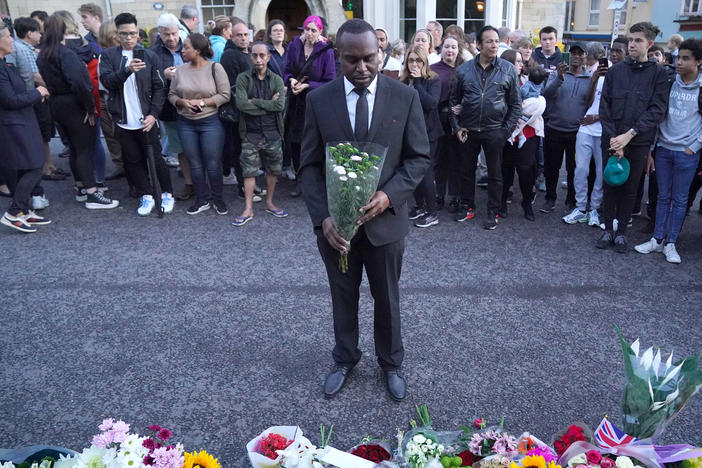 Mourners gather to lay flowers outside Windsor Castle in Berkshire following the announcement of the death of Queen Elizabeth II on Thursday.