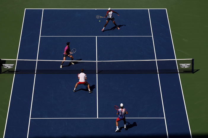 Rajeev Ram and Joe Salisbury return a shot against Neal Skupski and Wesley Koolhof during their Men's Doubles Final match on Friday at the U.S. Open.