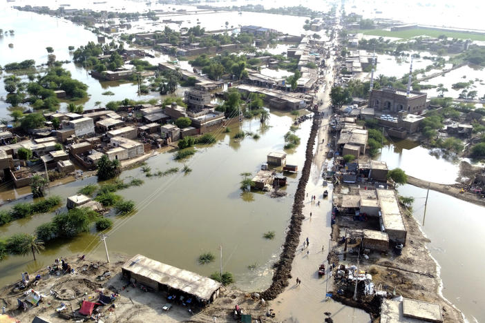 Homes are surrounded by floodwaters in Sohbat Pur city of Jaffarabad, a district of Pakistan's southwestern Baluchistan province, Aug. 29, 2022. The U.N. weather agency predicts the phenomenon known as La Nina is poised to last through the end of this year — its third year in a row — and affect meteorological patterns like drought and flooding worldwide.