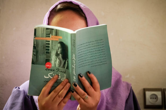 A group of teen girls in Afghanistan is reading and discussing Anne Frank's classic book in a secret book club.