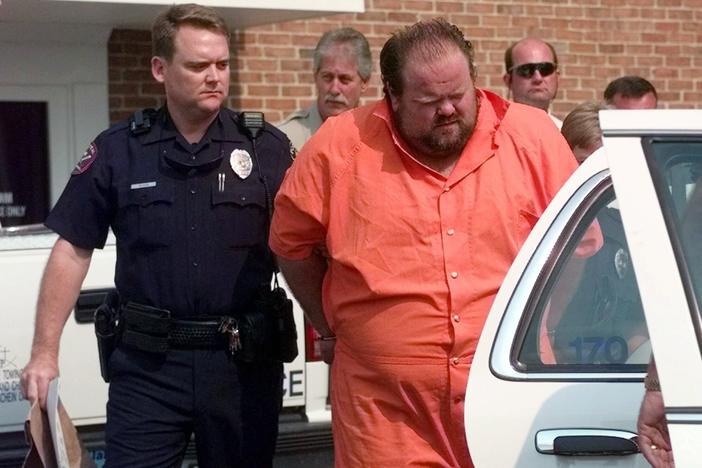 Officials escort murder suspect Alan Eugene Miller away from the Pelham City Jail in Ala., on Aug. 5, 1999. Miller, scheduled to be put to death by lethal injection on Sept. 22, 2022, for a workplace shooting rampage in 1999 that killed three men, says the state lost the paperwork he turned in selecting an alternate execution method.