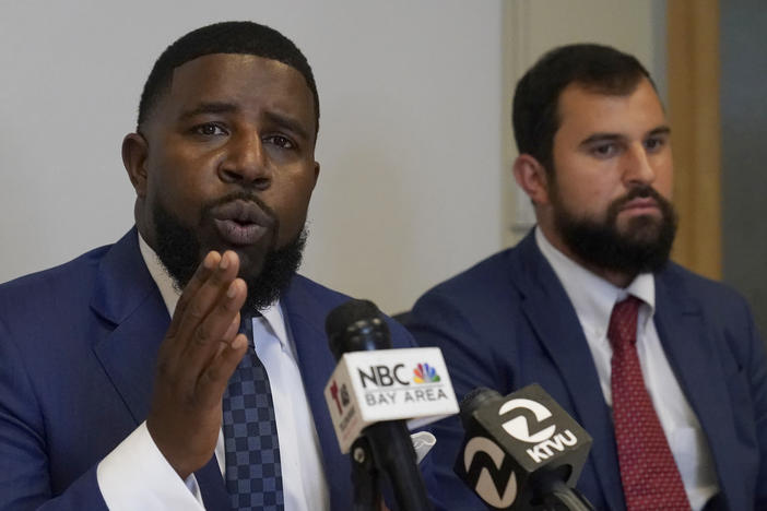 Attorneys Adanté Pointer (left) and Patrick Buelna, who represent a woman whose DNA from a sexual assault case was used by San Francisco police to arrest her in an unrelated crime, speak during a news conference announcing their lawsuit against the city on Monday.