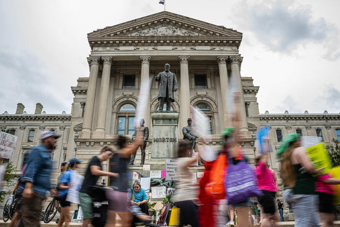 Protesters march outside the Indiana state Capitol building on July 25, 2022, in Indianapolis as activists gathered during a special session.