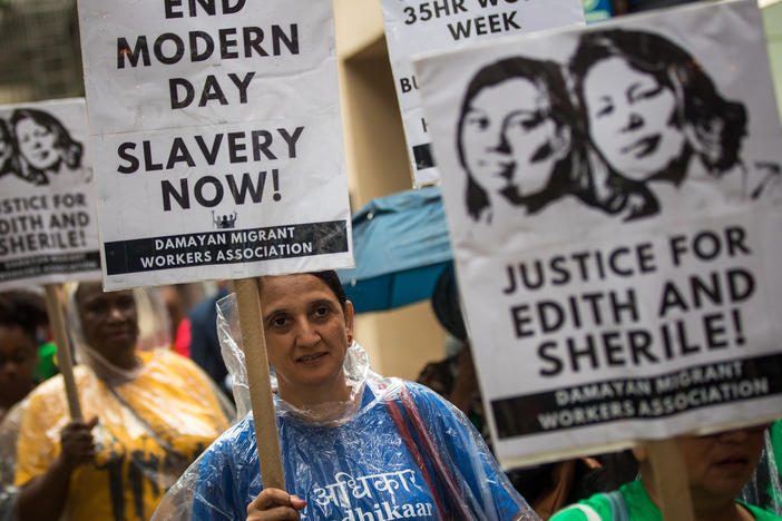 Activists march toward the German consulate during a rally to support two Filipina domestic workers in their lawsuit against a German diplomat.