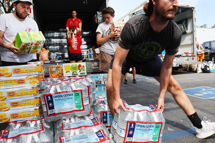 Volunteers deliver water and other items to the homeless in Los Angeles. Poverty rates dropped in 2021 thanks in part to pandemic policy measures, but poverty advocates fear they will rise again without those measures in place.